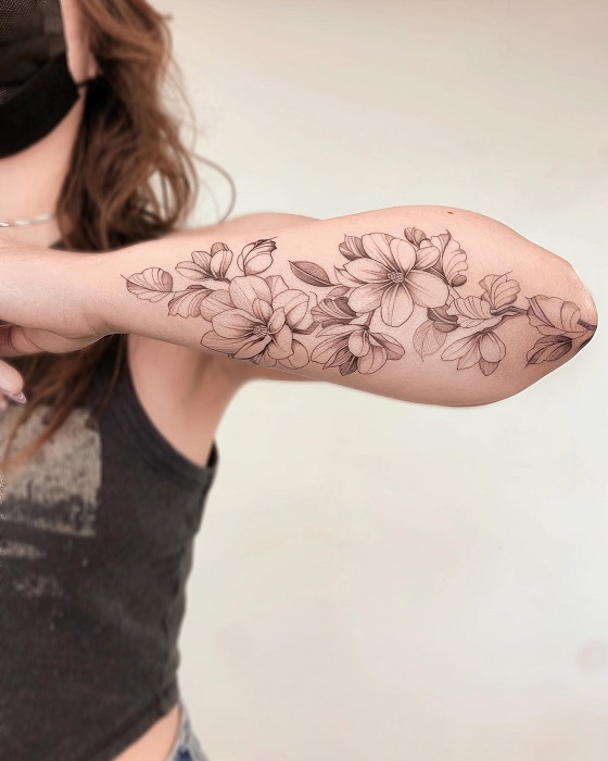 fine line magnolia half sleeve tattoo