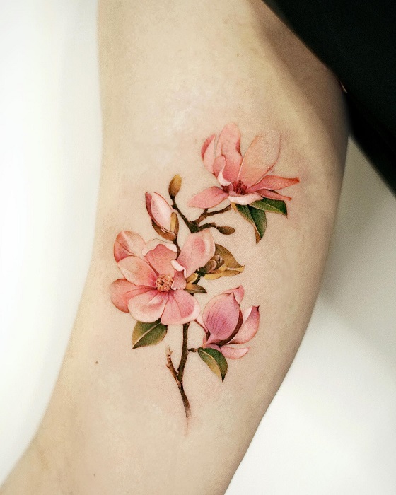 pink magnolia flower arm tattoo