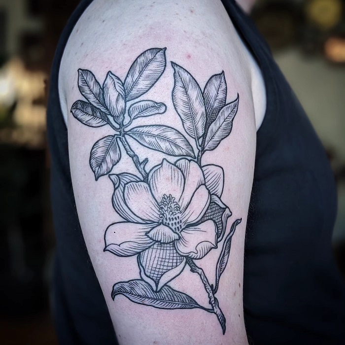 illustrative magnolia upper arm tattoo