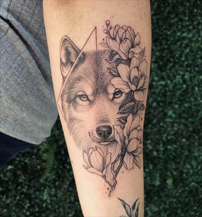 wolf and magnolia forearm tattoo