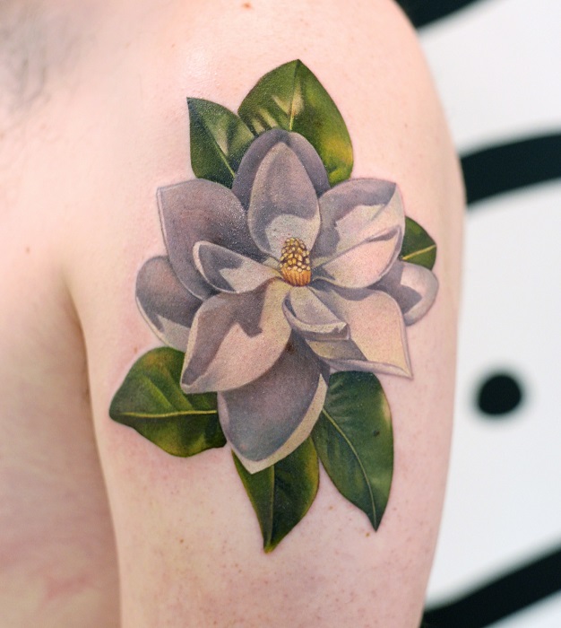 realistic magnolia upper arm tattoo