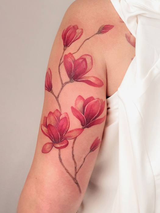 pink magnolia upper arm tattoo