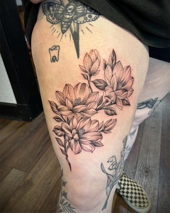 magnolia thigh tattoo