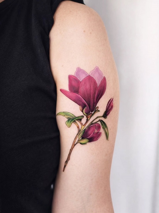 purple magnolia upper arm tattoo