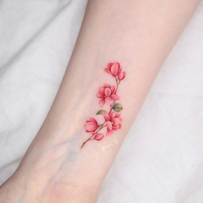 small pink magnolia wrist tattoo